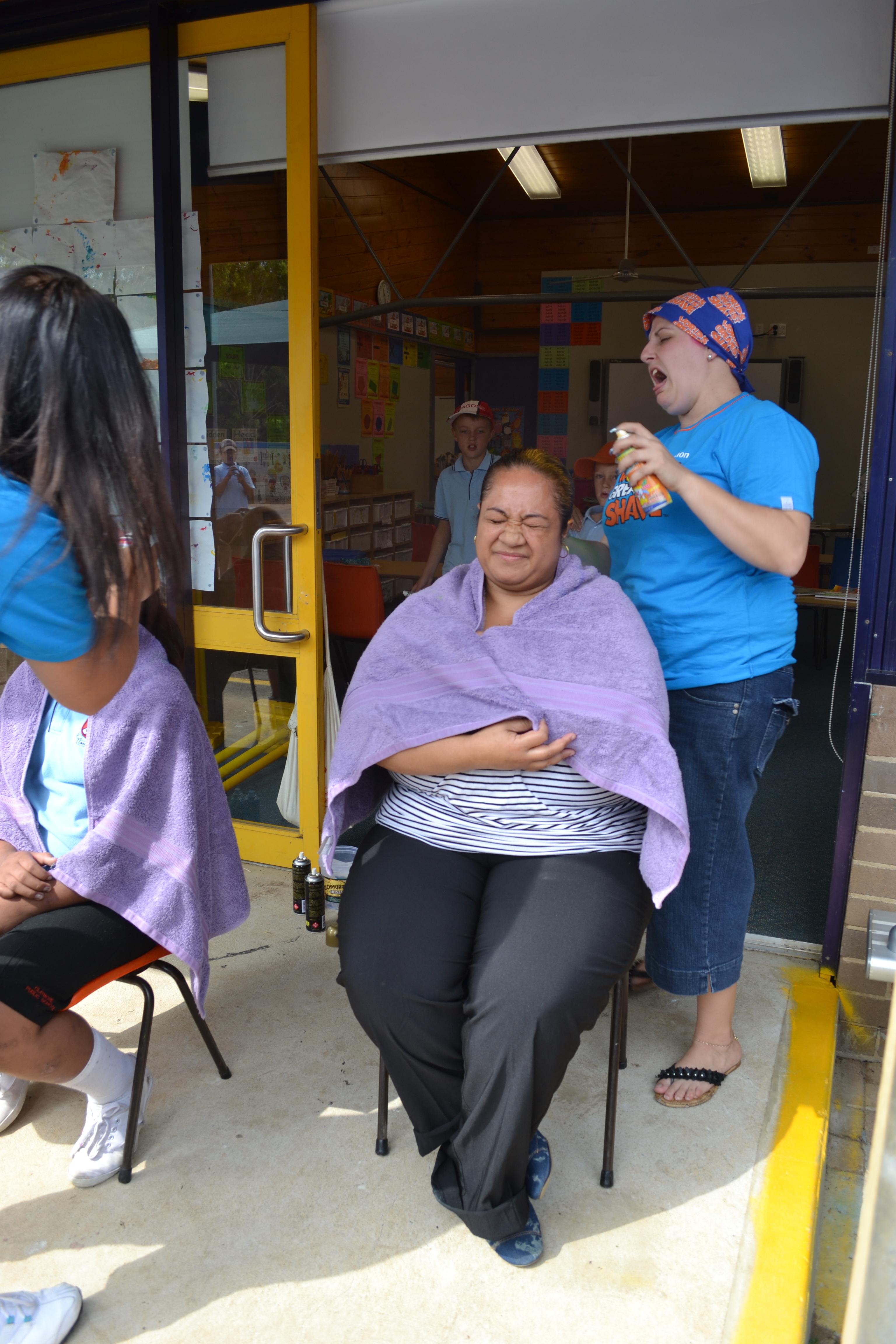 parents line up to have their hair coloured