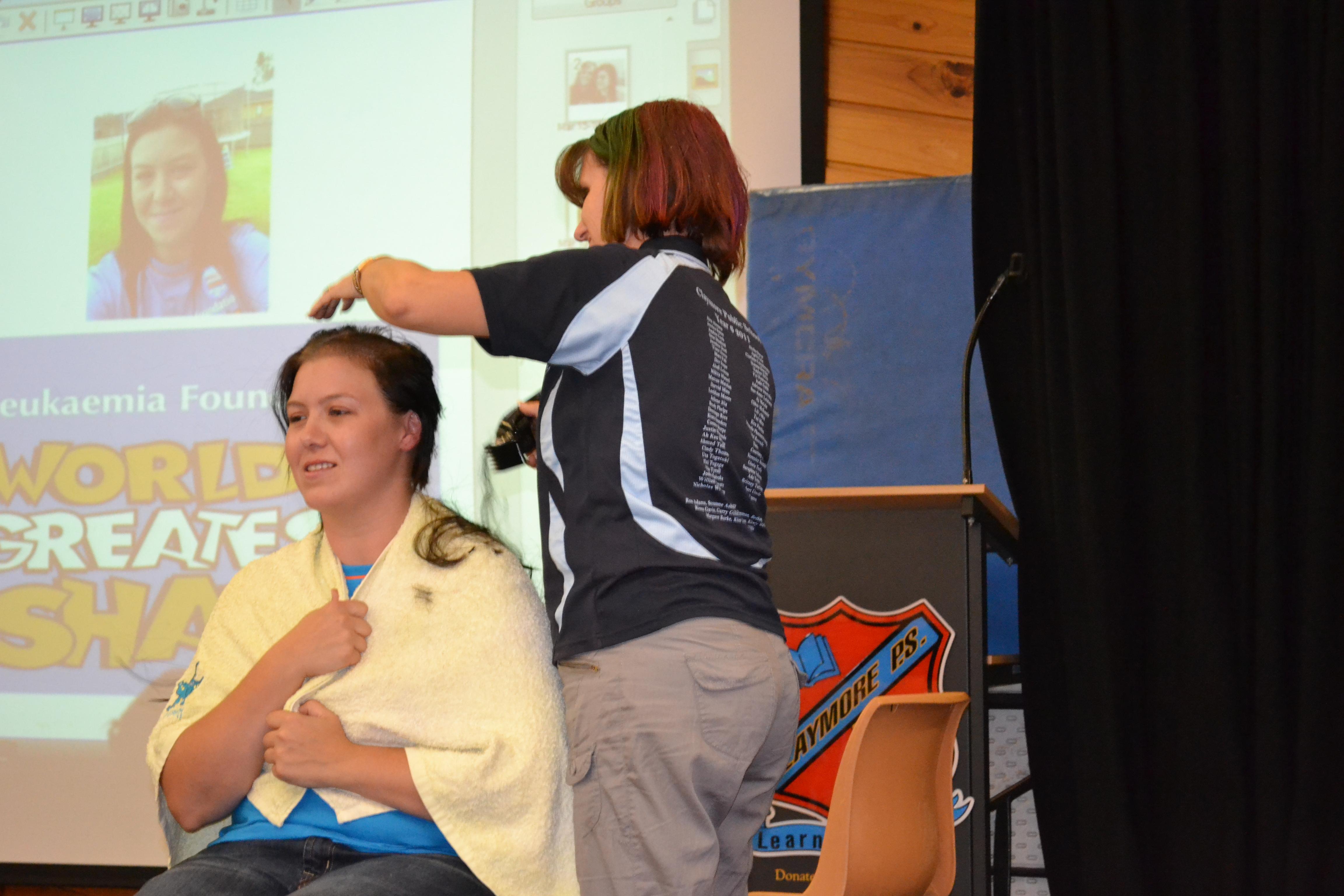 Teacher having head shaved